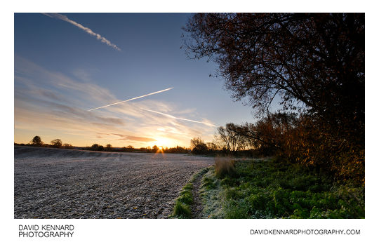 Frosty ploughed field at sunrise